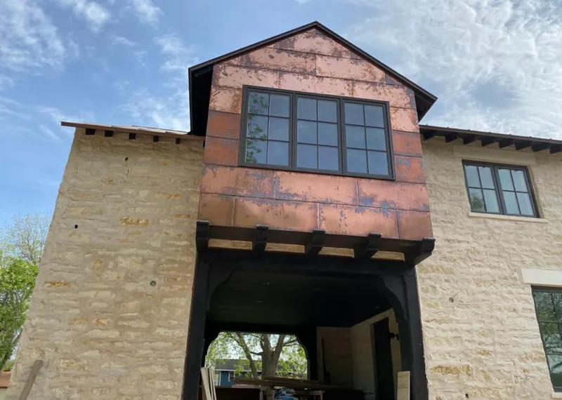 Copper metal panel facade on a stone building for Skylight Installation in Killeen